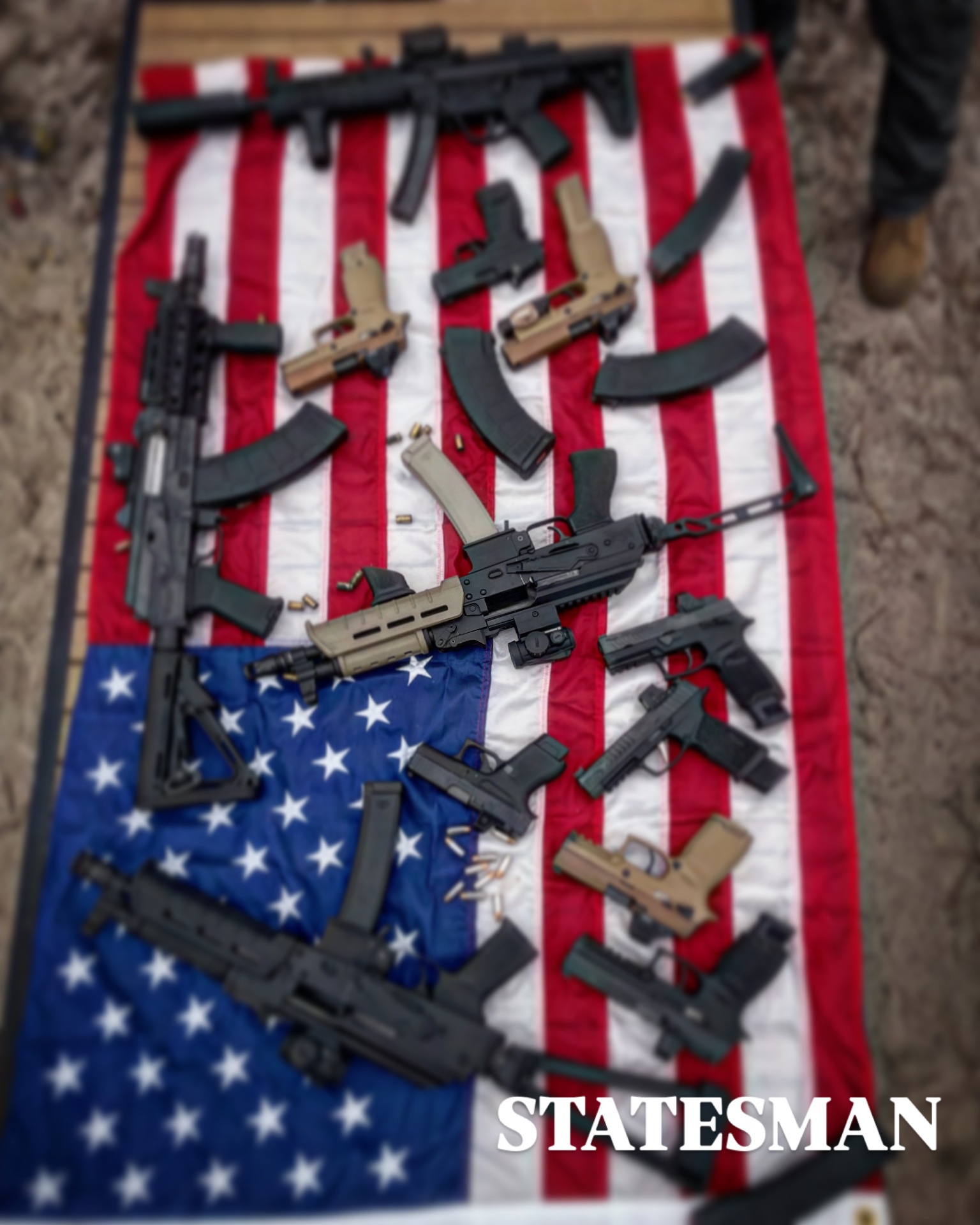 Rifles and pistols arranged on an American flag
