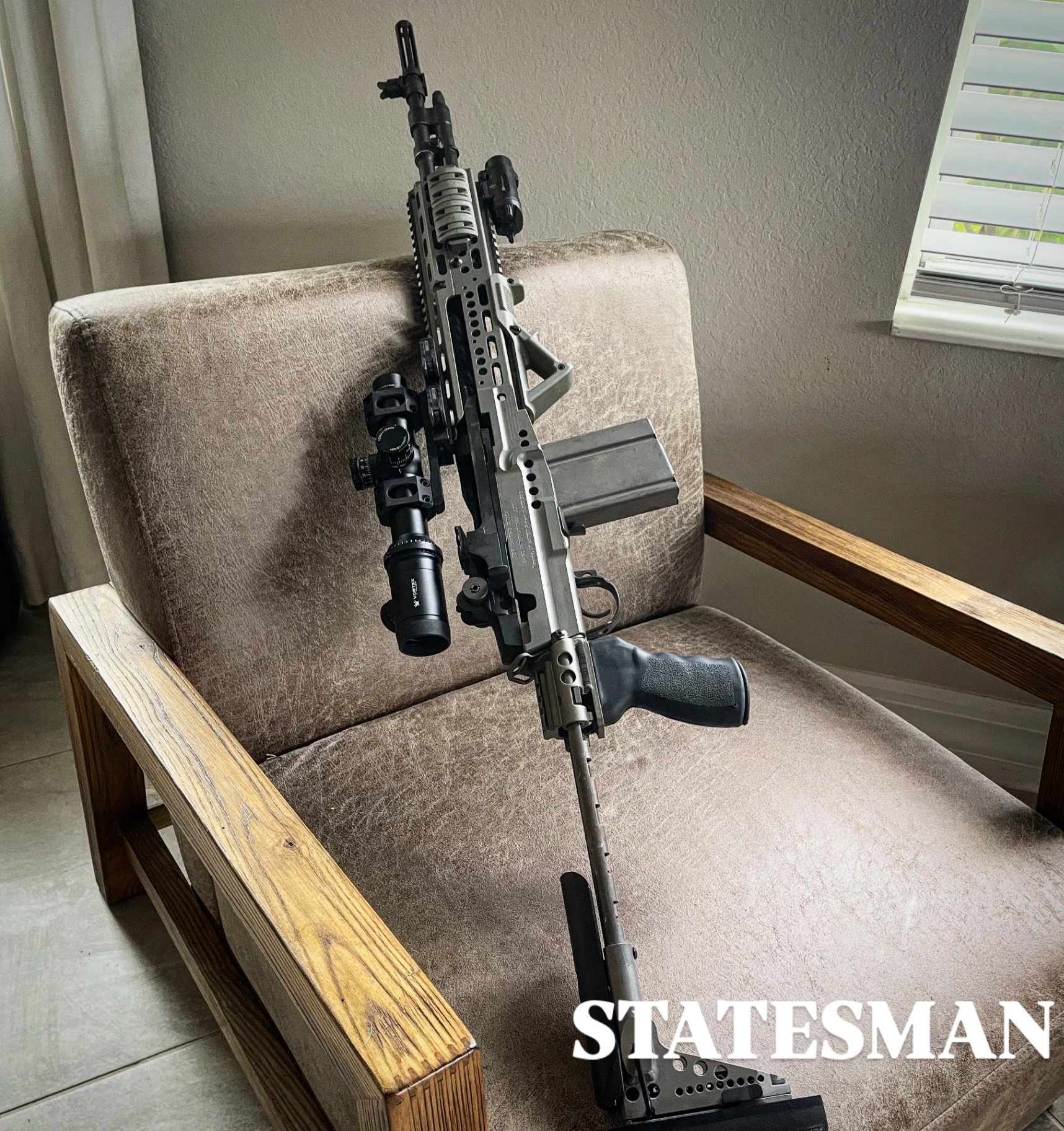 Precision rifle staged on leather chair